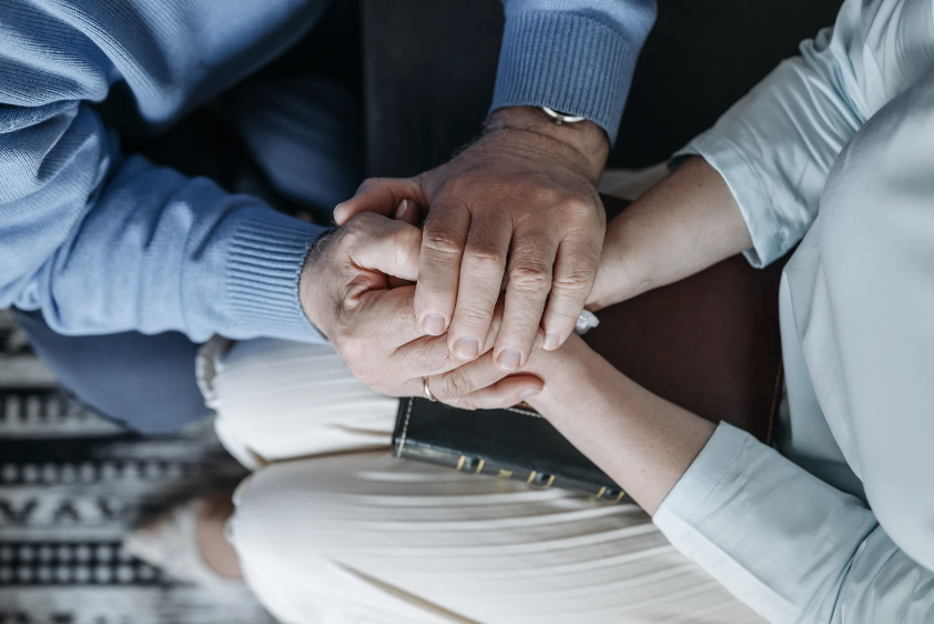 Aerial view of two people holding hands
